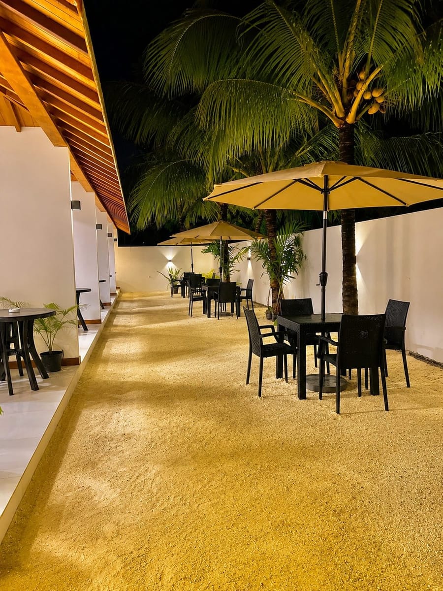 Vilu Residence courtyard and guesthouse building in Maamigili